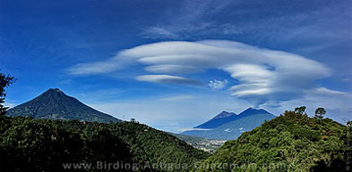 Small whirlwind clouds among the volcanoes of Antigua Guatemala: Agua, Fuego, and Acatenango.
