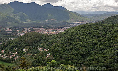Antigua Guatemala nestled among forested hillsides.