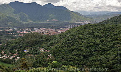Antigua Guatemala nestled among forested hillsides.